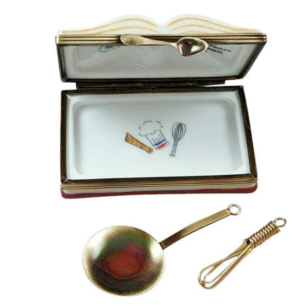 https://www.limogesboutique.com/cdn/shop/products/crepes-suzettes-cookbook-with-whisk-and-spoon-limoges-box-406630.jpg?v=1689857258